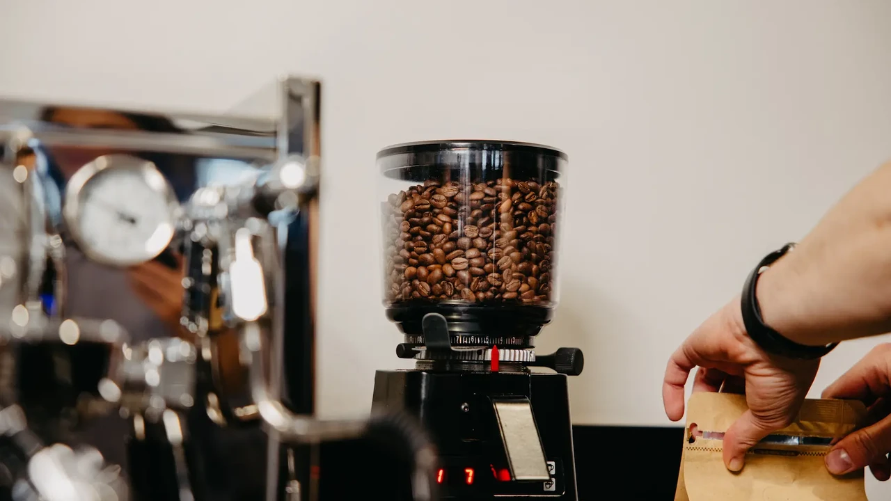 Close up on a plate of mashed potatoes, topped with baked pork chops with cream of mushroom soup, and a side of green beans.