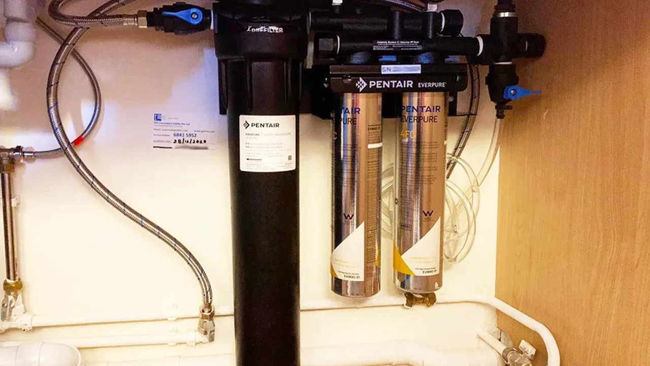 Close up on a plate of mashed potatoes, topped with baked pork chops with cream of mushroom soup, and a side of green beans.