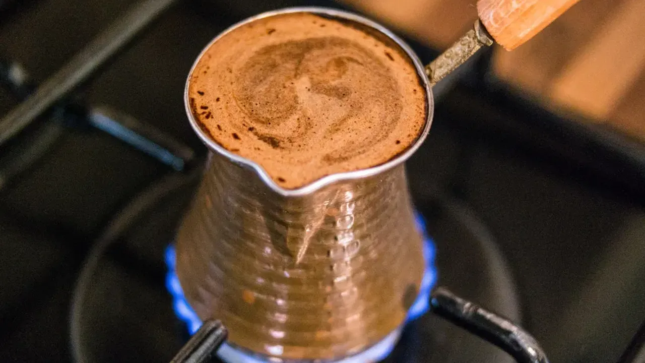 Two mint chocolate milkshakes with whipped cream and green sprinkles.