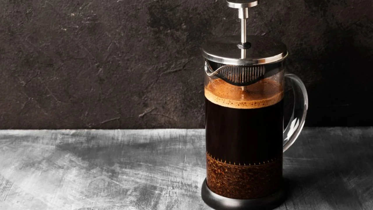 Close up on a plate of mashed potatoes, topped with baked pork chops with cream of mushroom soup, and a side of green beans.